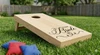 team bride and team groom vinyl sticker decal set applied to cornhole boards for wedding reception party game setup sized 20 by 12 inches