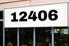 large Archivo Black vinyl storefront numbers applied to modern business window with bold wide geometric typography
