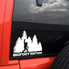 bigfoot edition forest vinyl sticker decal featuring sasquatch throwing metal horns while walking through pine trees