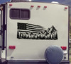 Distressed American flag mountain and pine forest vinyl decal displayed on the rear of an RV motorhome.