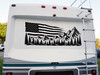 Distressed American flag mountain and pine forest vinyl decal displayed on the rear of an RV motorhome.
