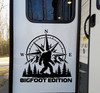 Bigfoot Edition vinyl decal with Sasquatch compass rose mountains and evergreen trees displayed on a truck window