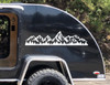 Grand Tetons vinyl decal with rugged mountain peaks and evergreen pine forest displayed on an RV camper exterior panel