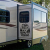 I Go Where I'm Towed vinyl decal featuring a travel trailer, mountains and pine trees displayed on a camper exterior