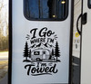 I Go Where I'm Towed vinyl decal featuring a travel trailer, mountains and pine trees displayed on a camper exterior