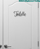Toilette bathroom door vinyl decal featuring elegant Nouradilla script lettering with decorative flourishes, available in eight sizes from a 2-pack of 4.5 x 2 inch decals to a single 22.5 x 10 inch decal for powder rooms and restroom doors