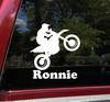 Personalized dirt bike vinyl decal featuring motocross rider doing a wheelie with custom name and racing number