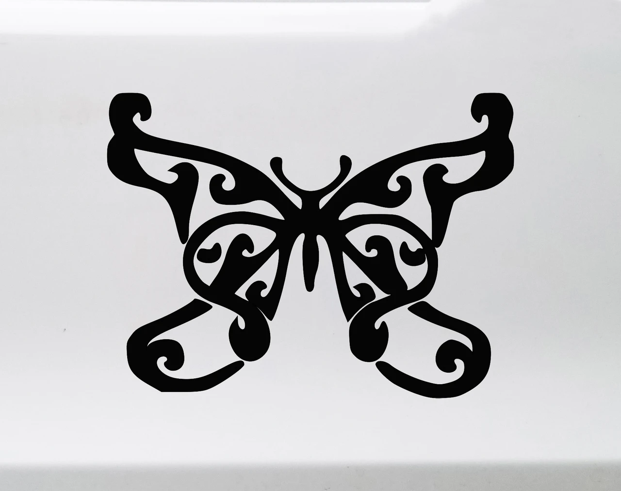 Decorative butterfly vinyl decal with ornamental curls and swirling wing design