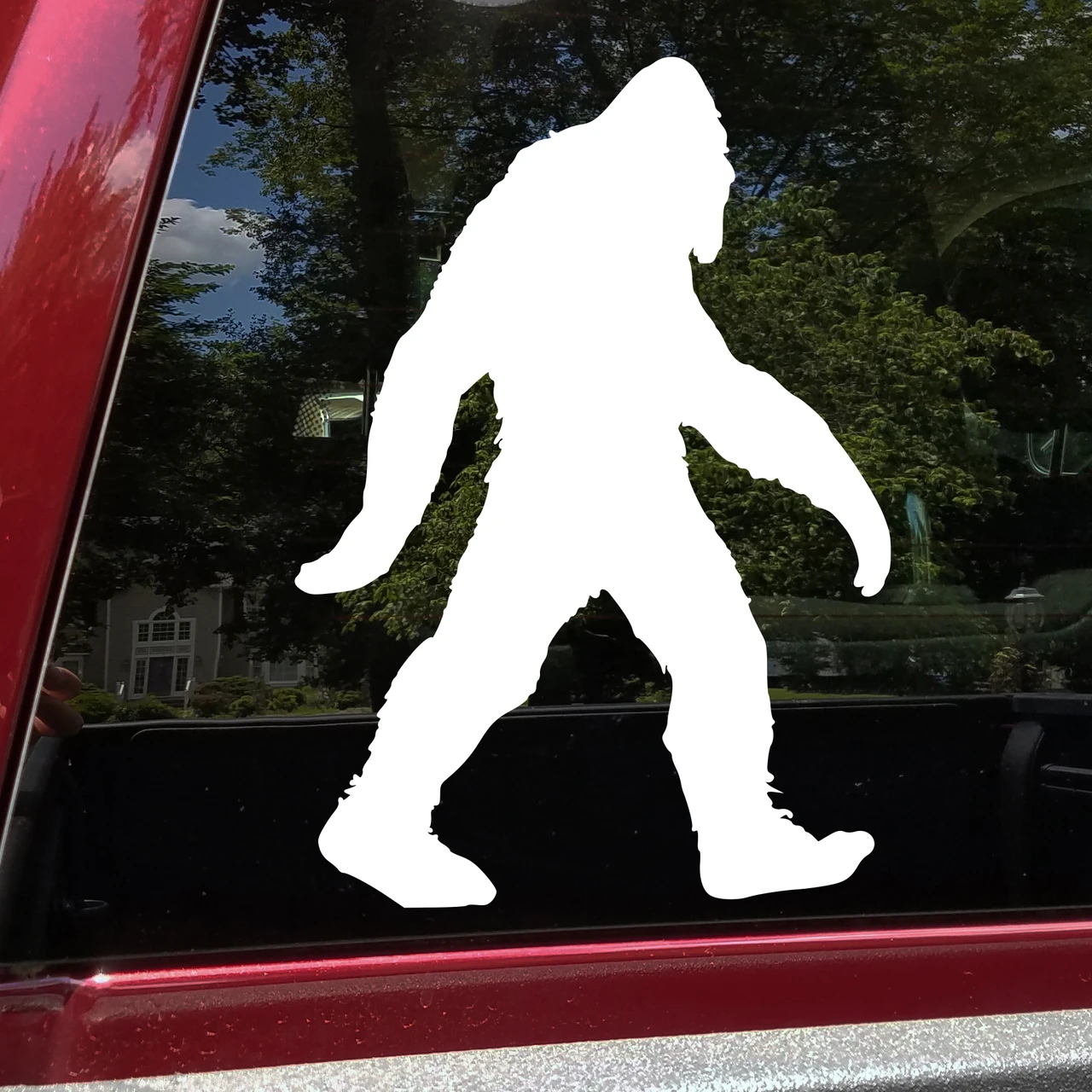 Walking Bigfoot Sasquatch silhouette vinyl decal featuring a shaggy cryptid with long arms and large feet on a vehicle window