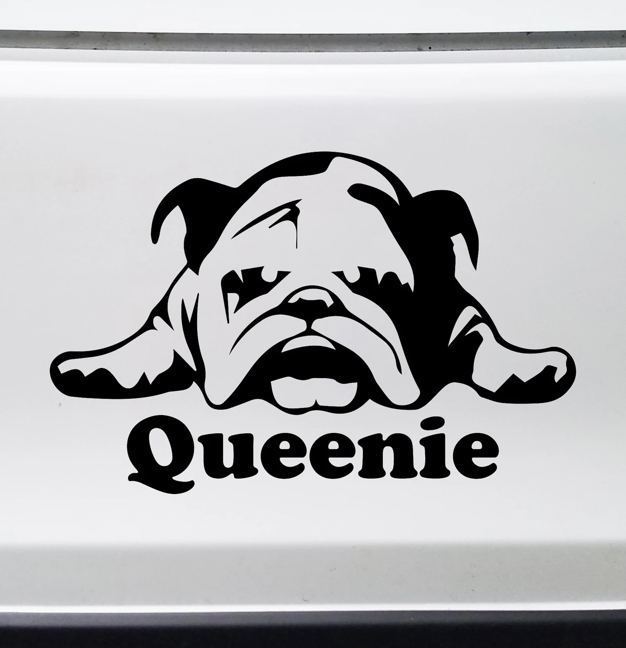 Personalized laying down Bulldog vinyl decal with stretched front paws and custom dog name