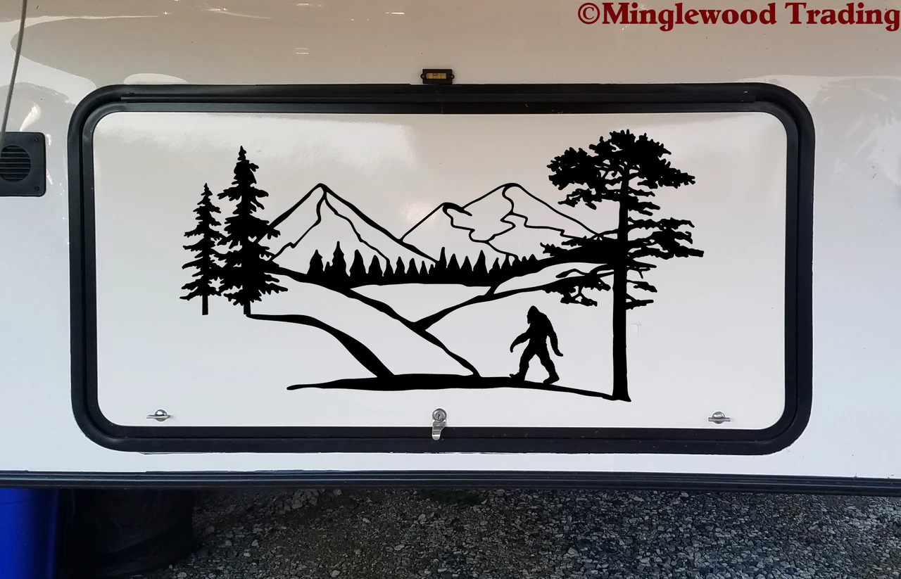 Bigfoot Sasquatch mountain forest landscape vinyl decal with pine trees and walking cryptid silhouette for RV campers travel trailers and motorhomes