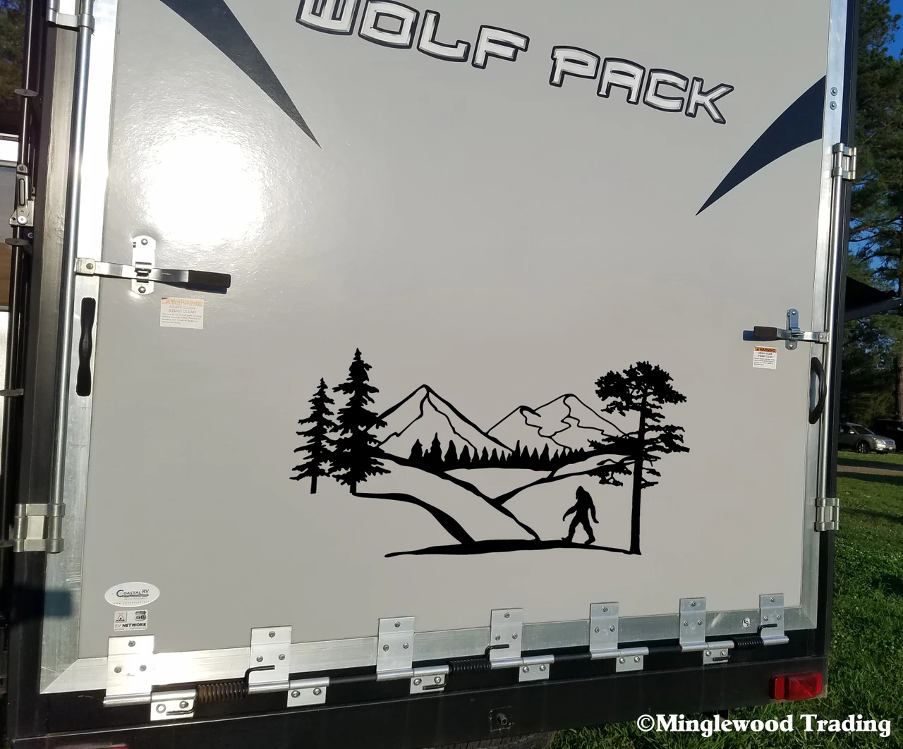 Bigfoot Sasquatch mountain forest landscape vinyl decal with pine trees and walking cryptid silhouette for RV campers travel trailers and motorhomes