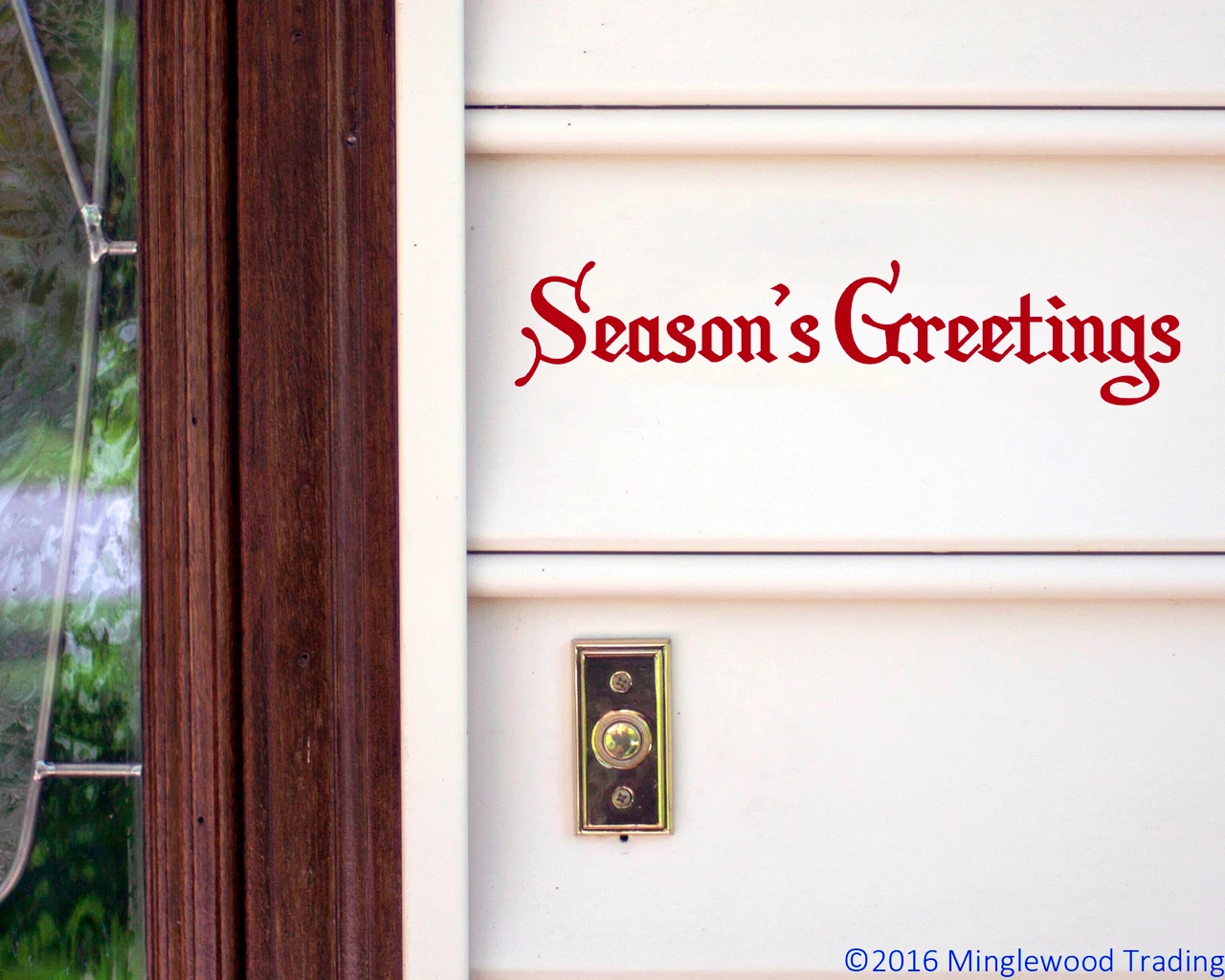 Season's Greetings Christmas vinyl decal in decorative Old English Gothic lettering displayed on glass window for holiday decorating