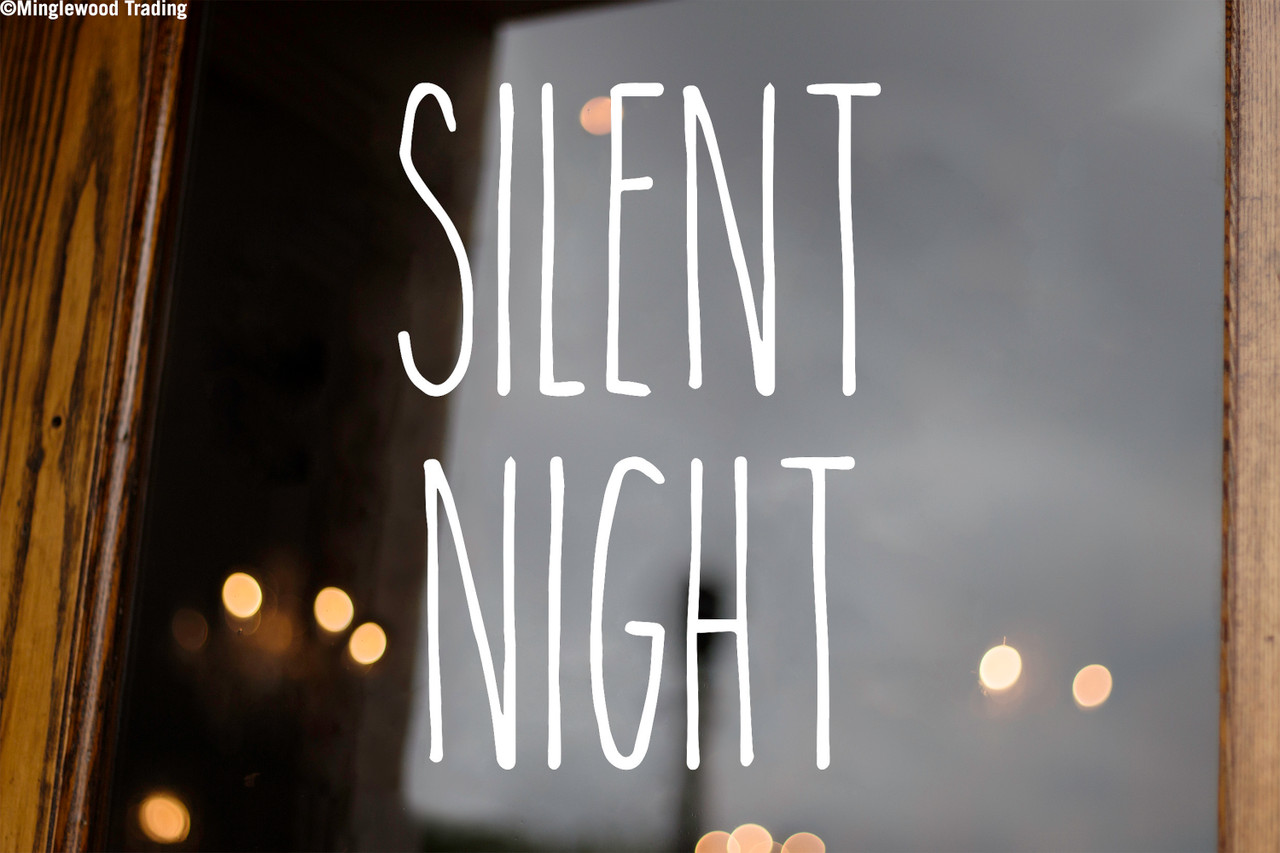Silent Night Christmas vinyl decal featuring tall skinny farmhouse style handwritten lettering arranged in two lines on glass window