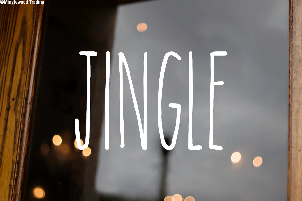 Jingle Christmas vinyl decal featuring tall skinny farmhouse style handwritten lettering displayed on glass window for holiday decorating