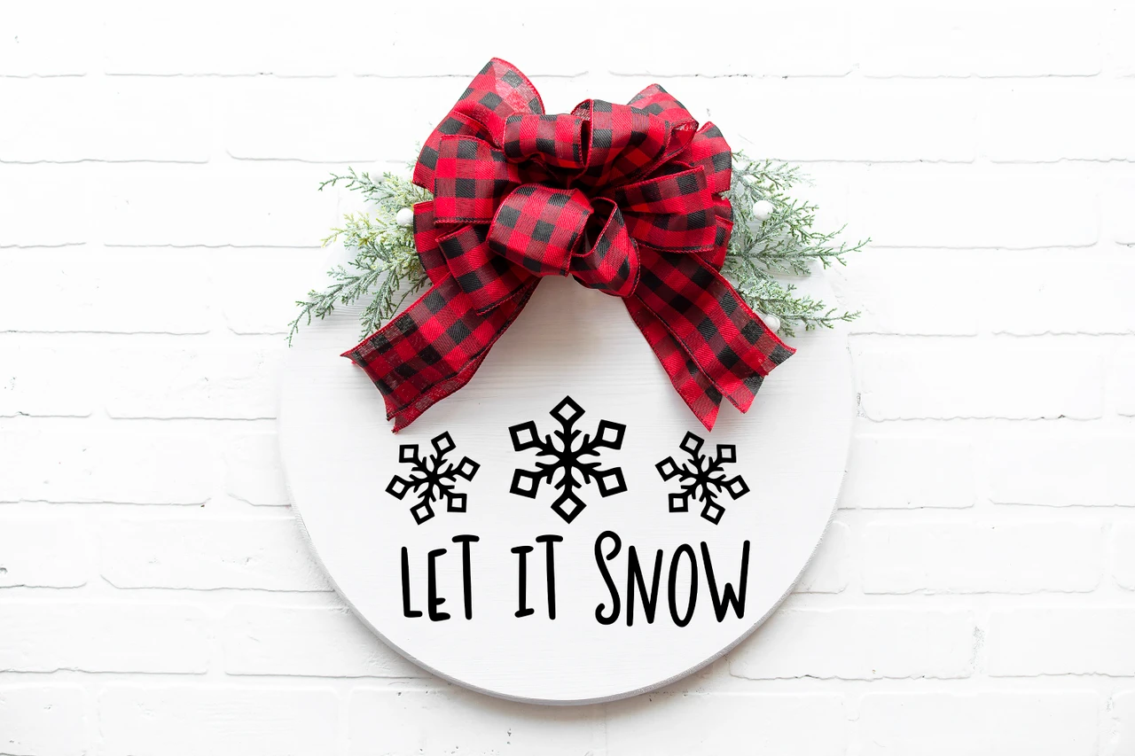Let It Snow winter vinyl window decal featuring three decorative snowflakes above playful hand-lettered holiday typography