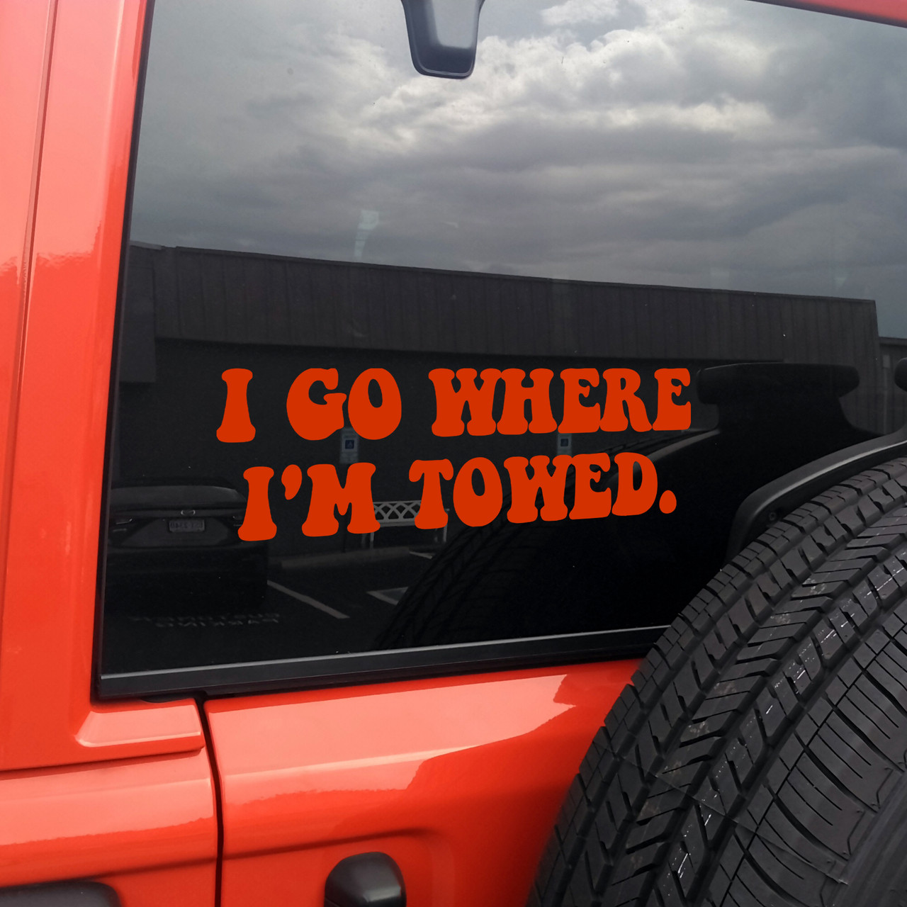 'I Go Where I'm Towed' vinyl decal on the back window of a car - perfect humorous car decal and funny bumper sticker