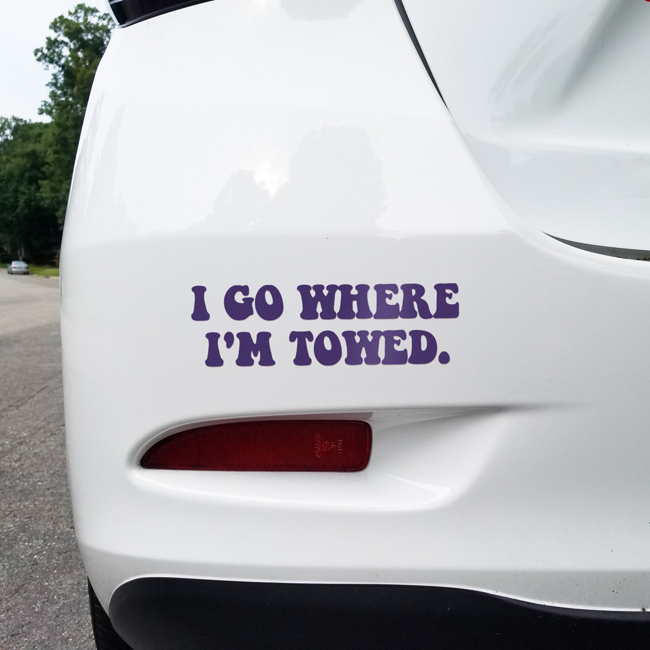 'I Go Where I'm Towed' vinyl decal on the bumper of a car - ideal funny bumper sticker