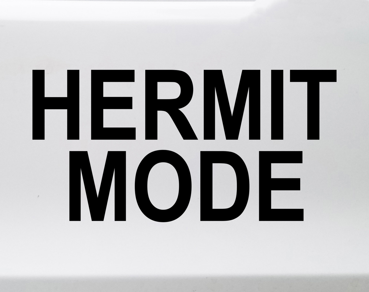 Hermit Mode vinyl decal featuring bold minimalist text expressing introvert solitude humor on a clean white background