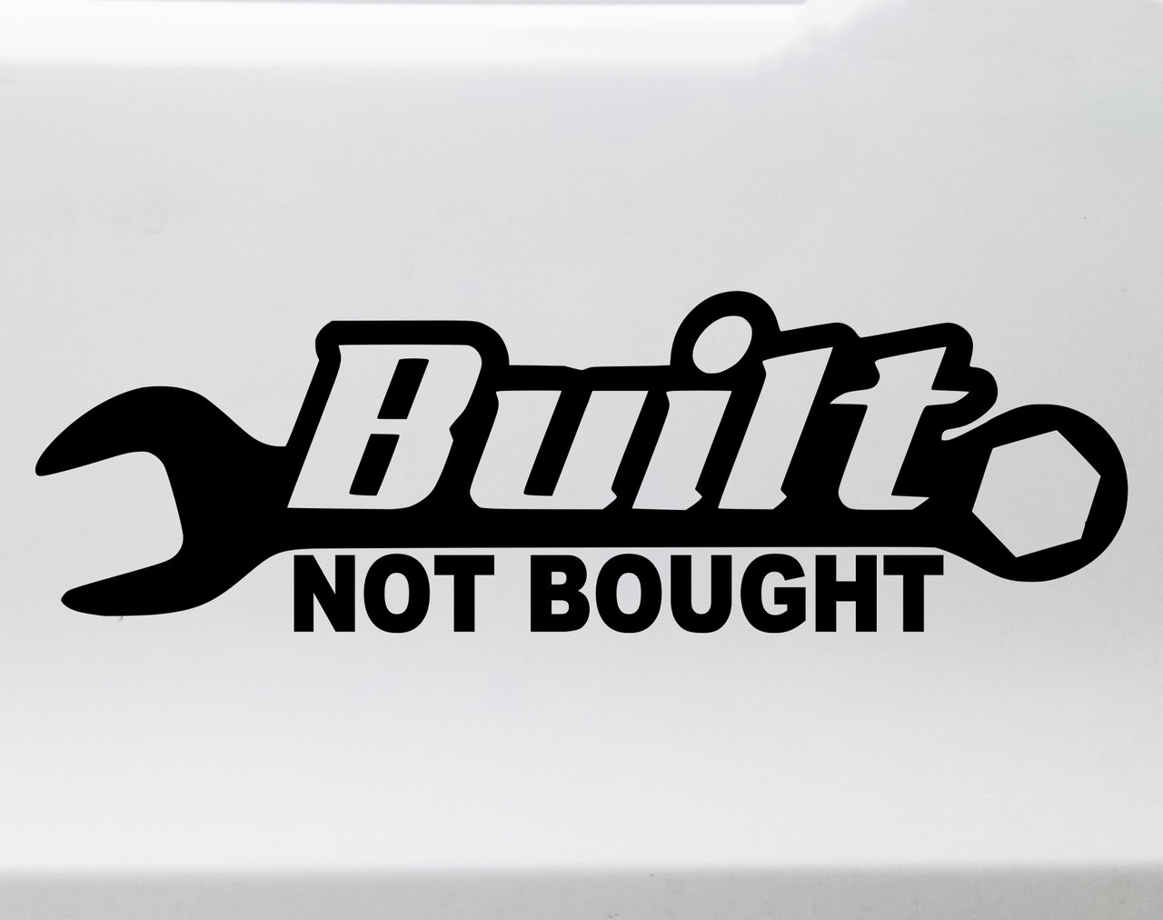 Built Not Bought wrench vinyl decal showing bold automotive lettering with a classic hand tool symbol in solid black on a white background