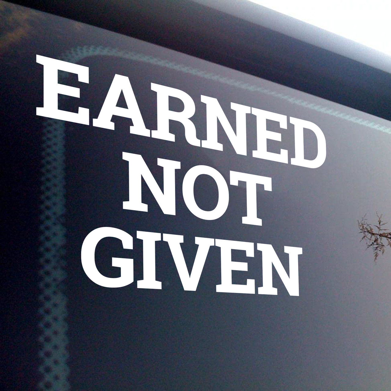 Earned Not Given vinyl decal featuring bold motivational lettering emphasizing discipline and earned success on a white background