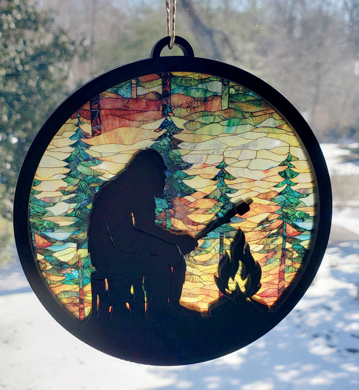 Bigfoot campfire round MDF suncatcher with pine tree forest and jute hanger cord
