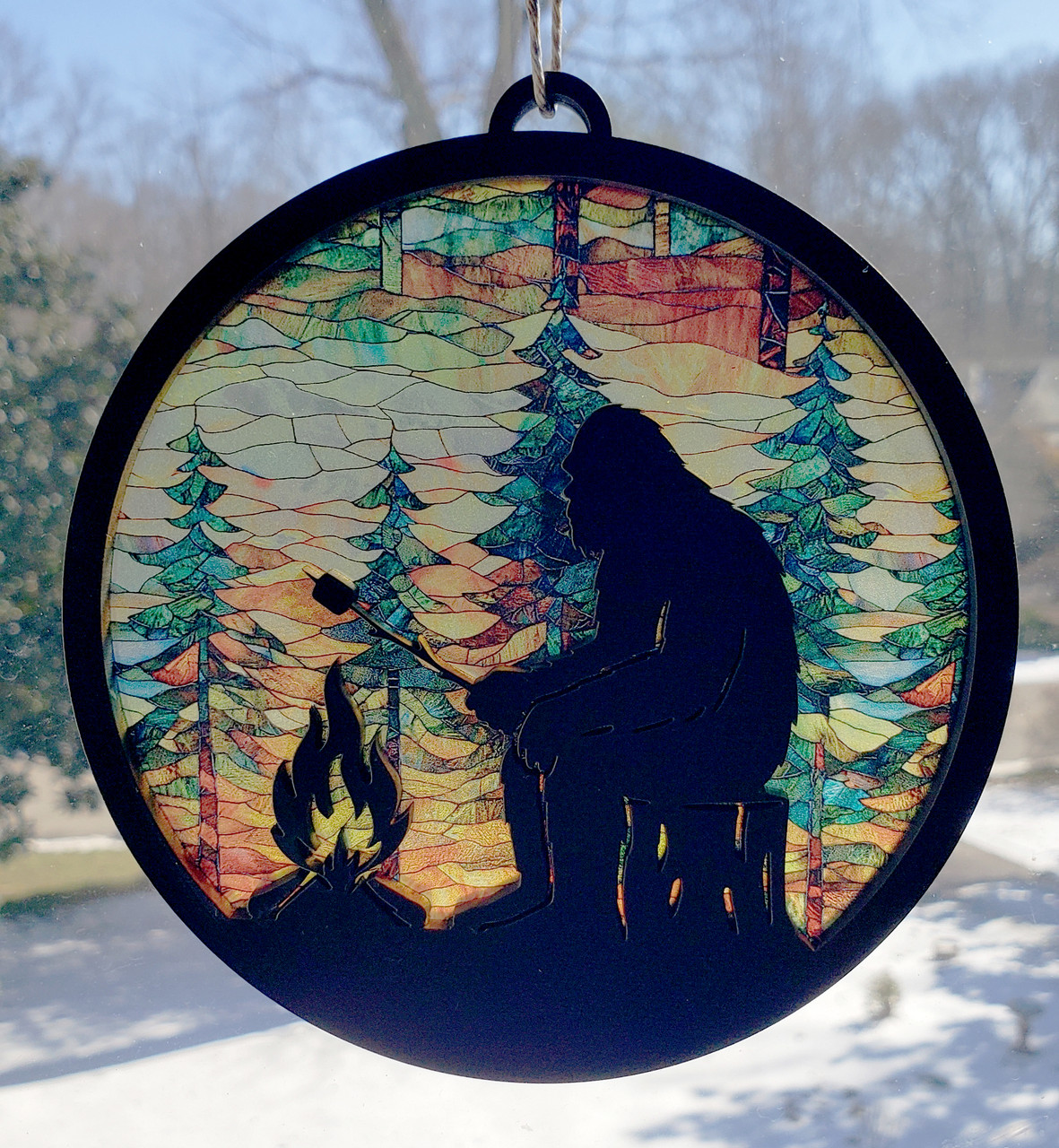 Bigfoot campfire round MDF suncatcher with pine tree forest and jute hanger cord
