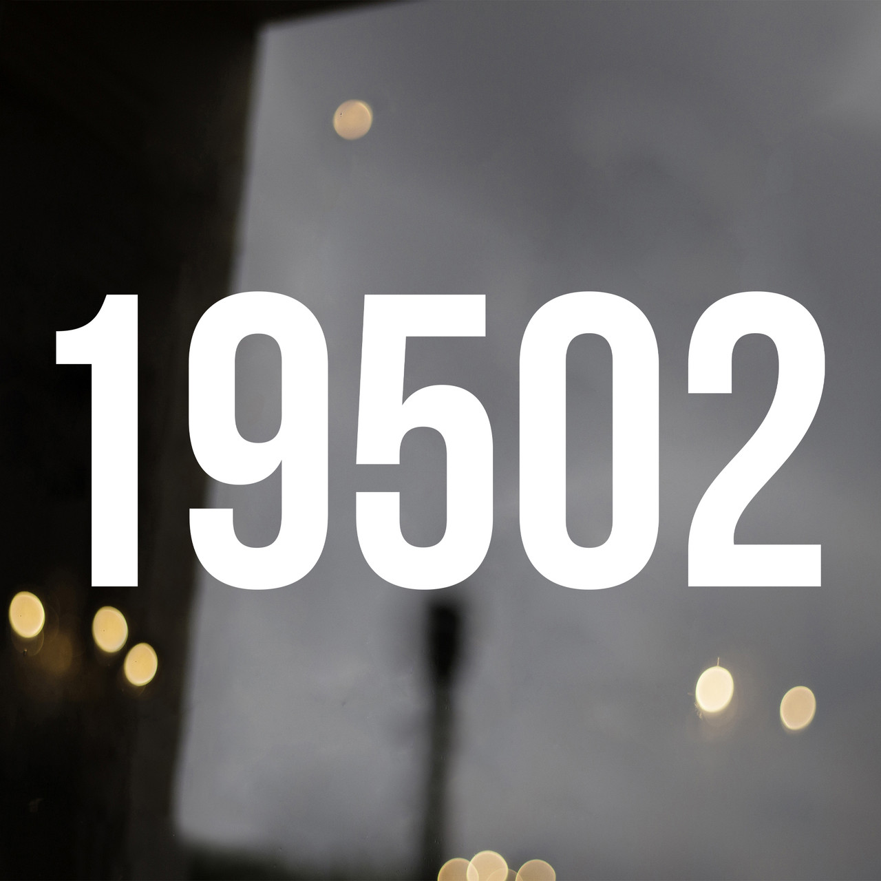 Large storefront address numbers vinyl decal in Bebas Neue font with modern minimalist business signage style