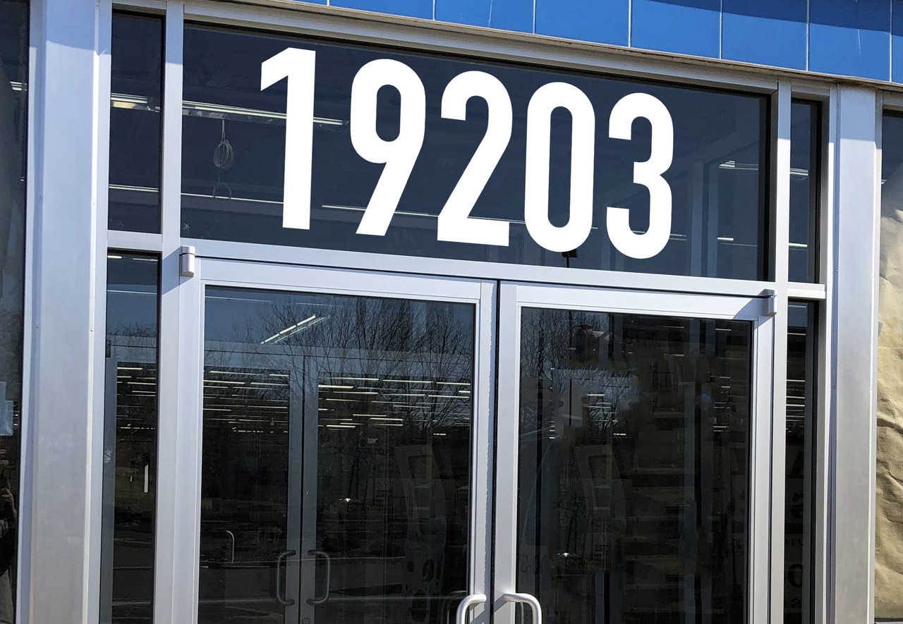 Large storefront address numbers vinyl decal in DIN 1451 font with modern minimalist business signage style