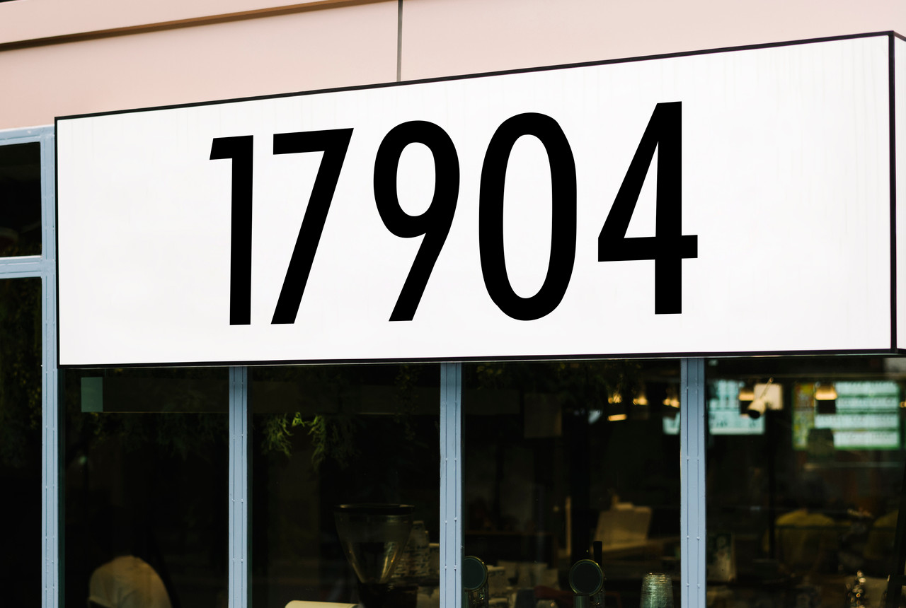 Large storefront address numbers vinyl decal in Futura Bold font with modern minimalist business signage style