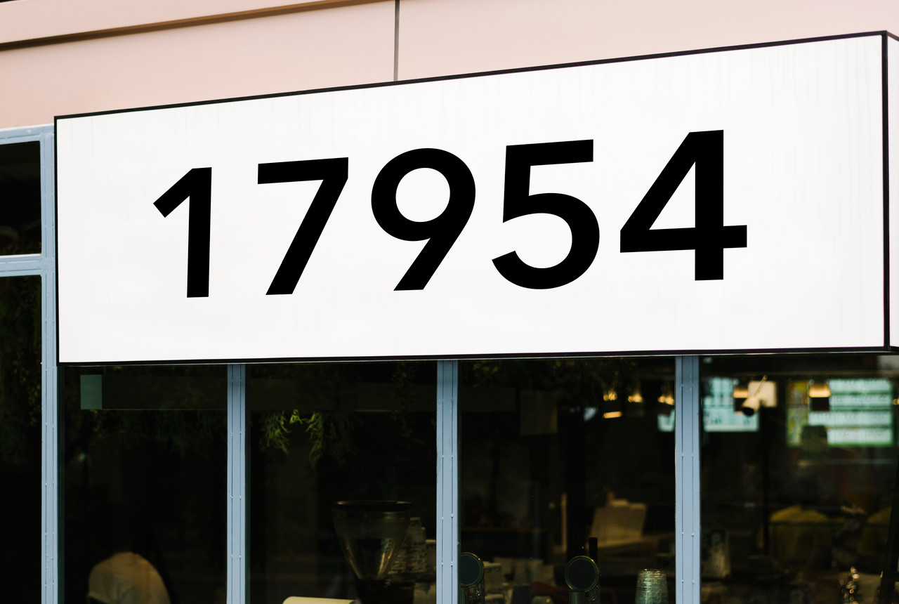 Large storefront address numbers vinyl decal in Avenir Next Demi font with modern minimalist business signage style