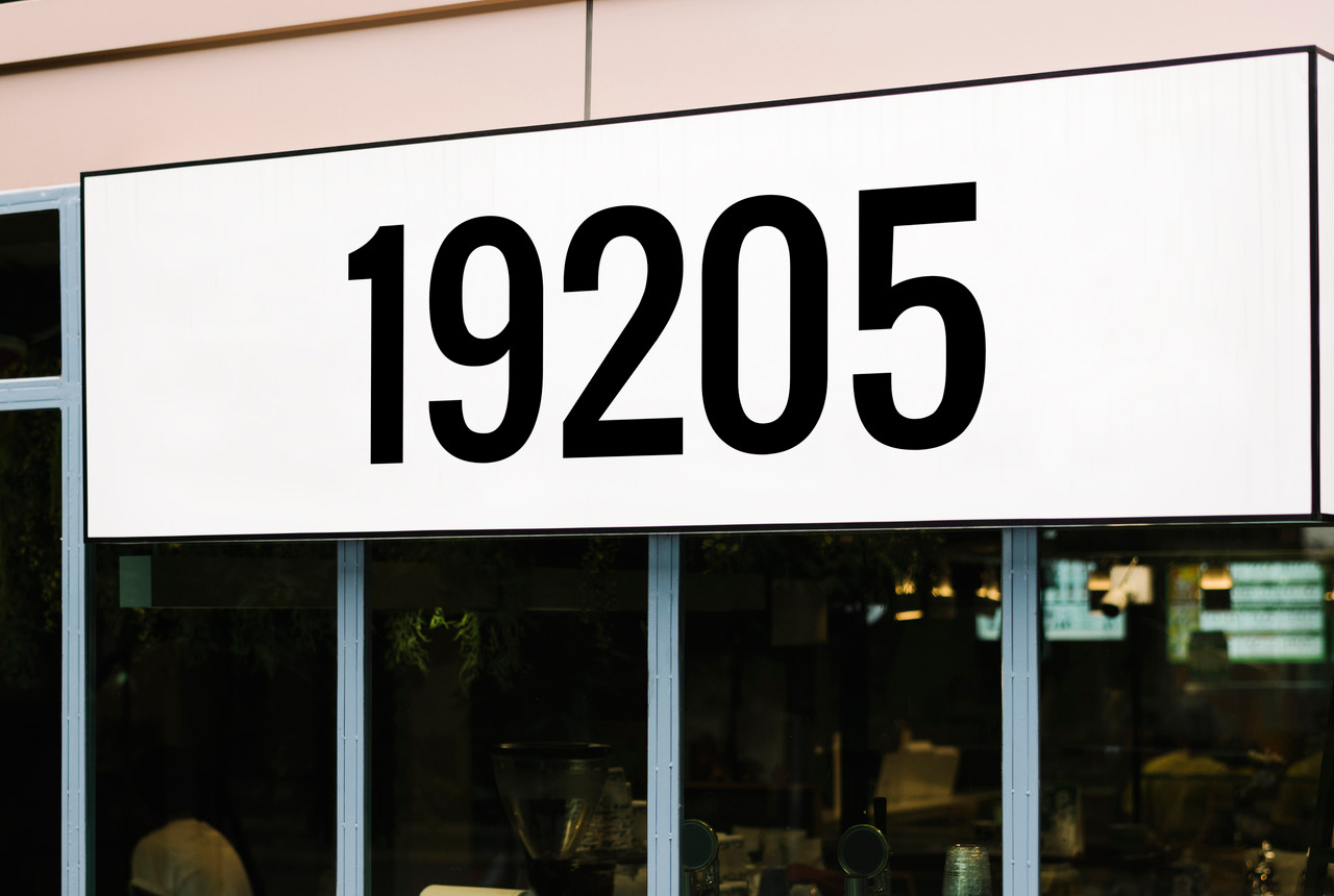 Large storefront address numbers vinyl decal in Oswald font with modern minimalist business signage style