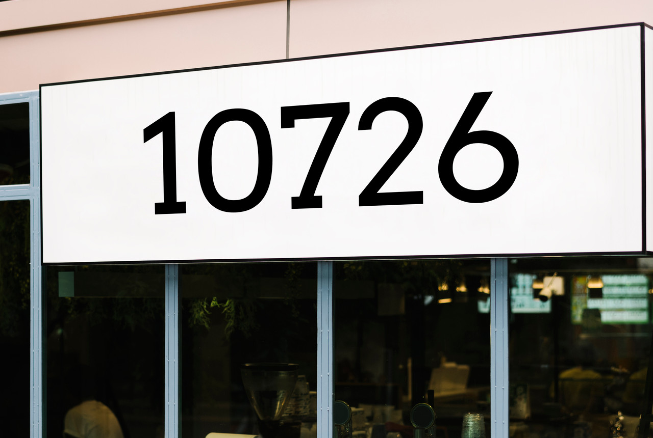 Arvo font storefront address numbers vinyl sticker decal applied to business window with clean slab serif lettering