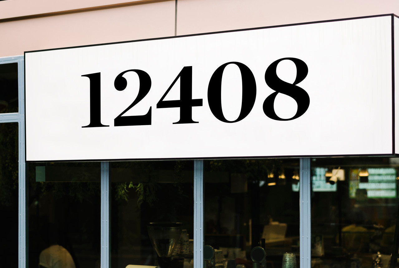 Chronicle Display Bold storefront address numbers vinyl sticker decal applied to business window with elegant serif lettering