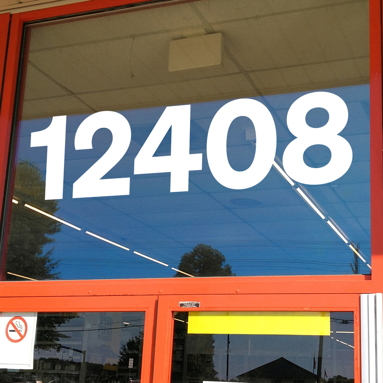 Sohne Bold storefront address numbers vinyl sticker decal applied to business window with clean modern sans serif lettering