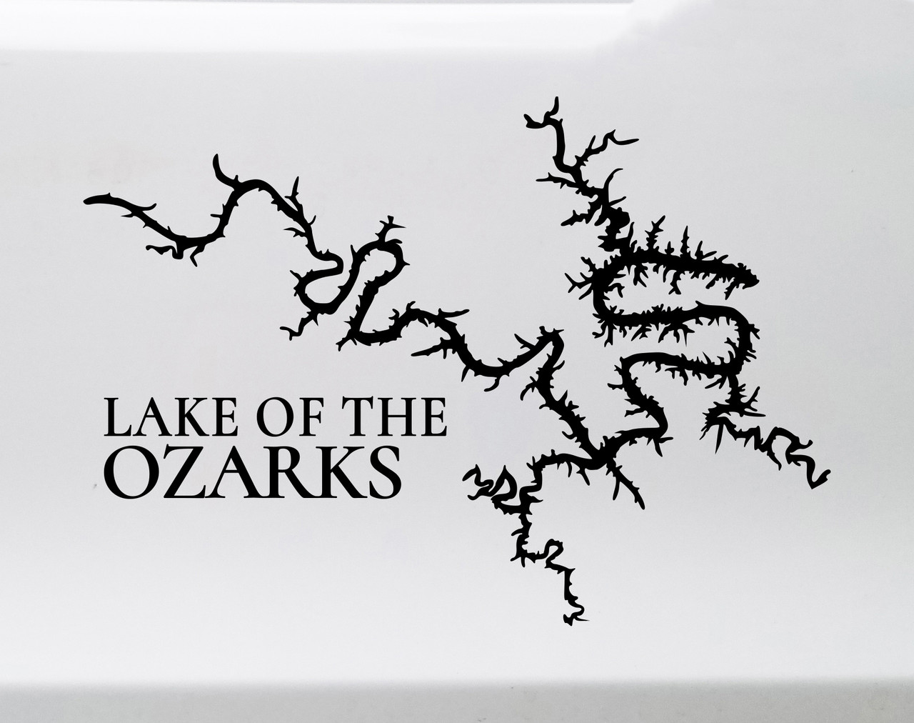 Lake of the Ozarks outline vinyl sticker decal with integrated text applied to car window showing Missouri lake map shape design