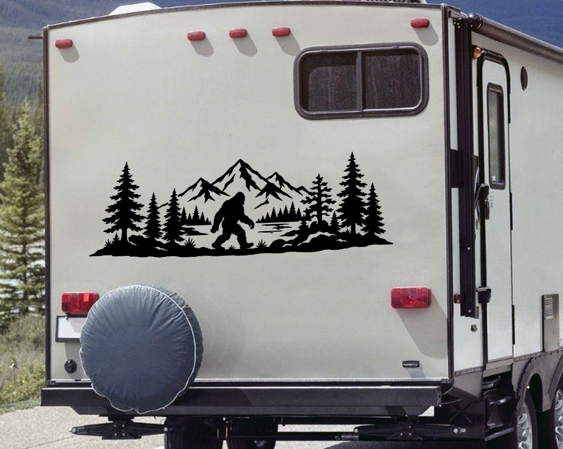 bigfoot sasquatch mountain forest vinyl sticker decal applied to rv window showing wilderness silhouette with trees and peaks
