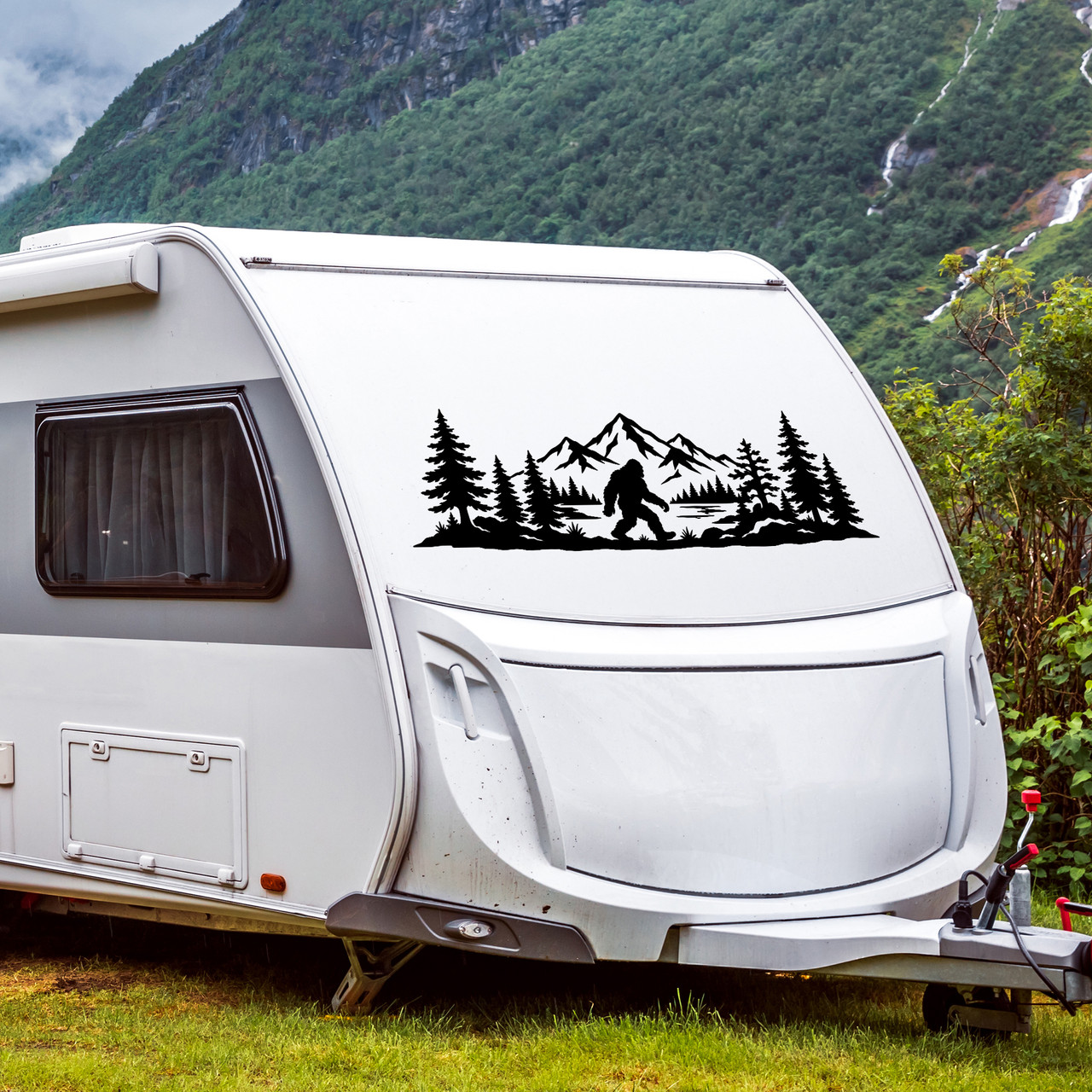 bigfoot sasquatch mountain forest vinyl sticker decal applied to rv window showing wilderness silhouette with trees and peaks