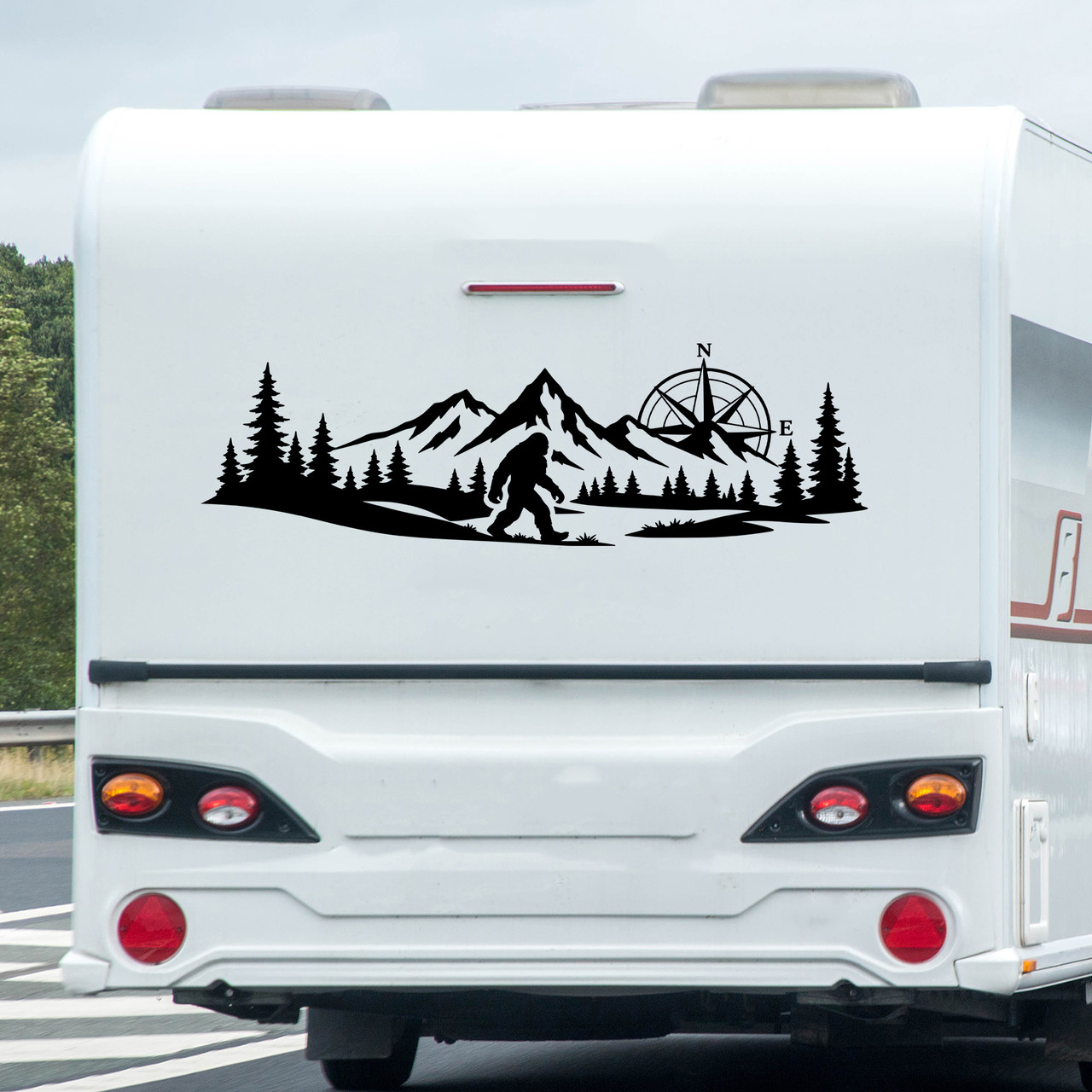 bigfoot sasquatch compass mountain forest vinyl sticker decal applied to rv window showing wilderness adventure silhouette design