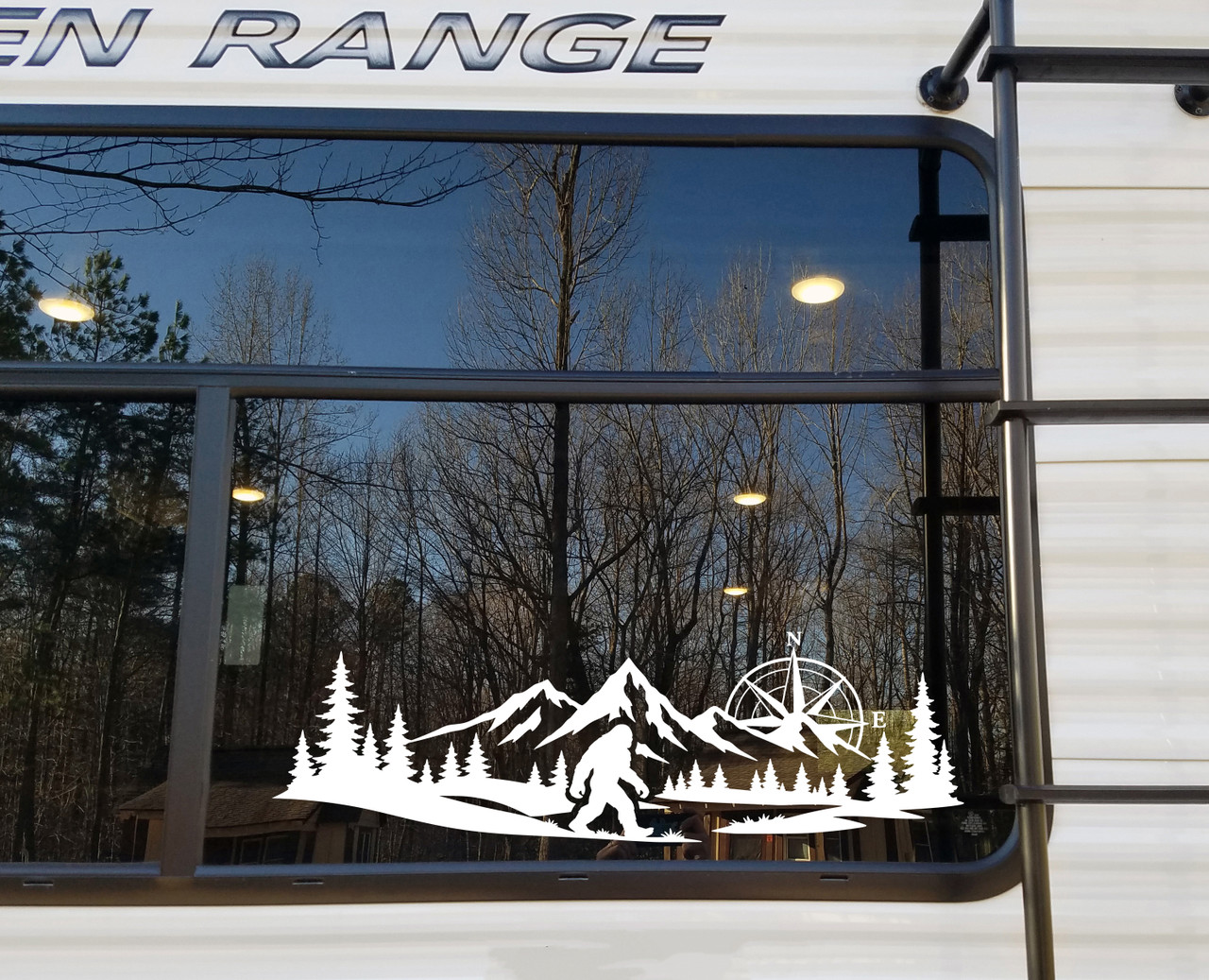 bigfoot sasquatch compass mountain forest vinyl sticker decal applied to rv window showing wilderness adventure silhouette design