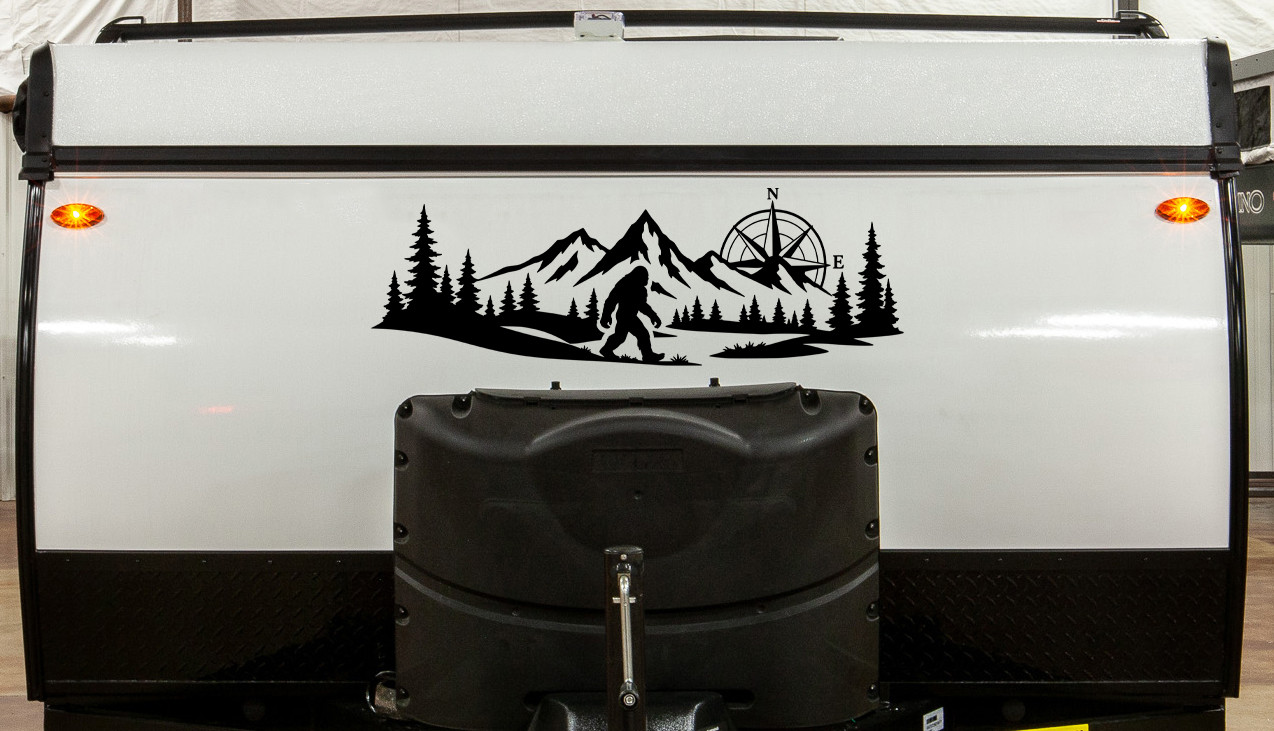 bigfoot sasquatch compass mountain forest vinyl sticker decal applied to rv window showing wilderness adventure silhouette design