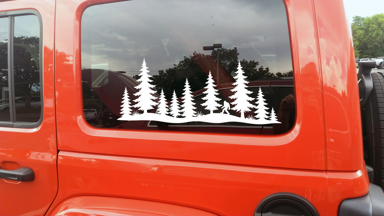 bigfoot sasquatch walking pine forest vinyl sticker decal applied to rv camper rear window with wilderness silhouette design