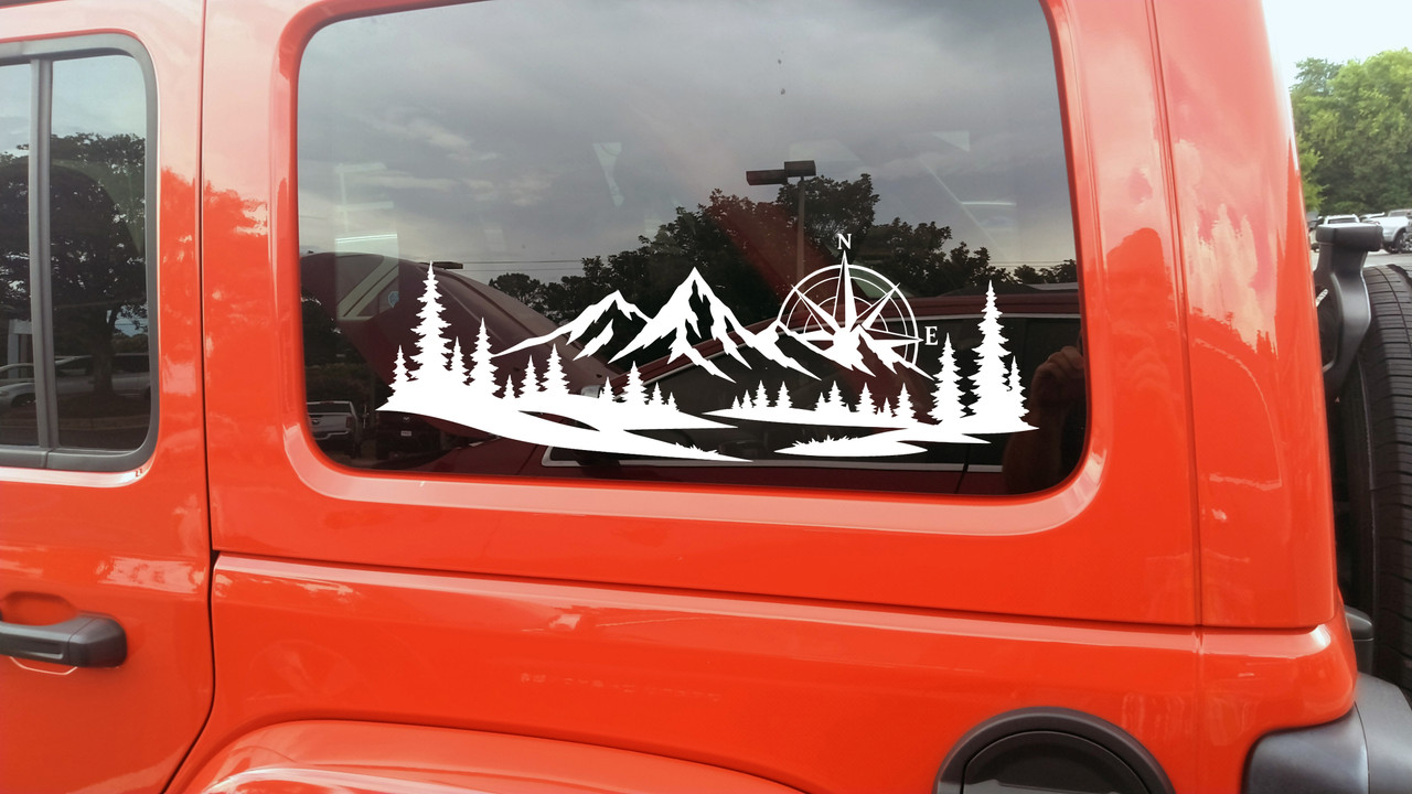 mountain forest compass rose vinyl sticker decal applied to rv camper rear window with outdoor adventure landscape design