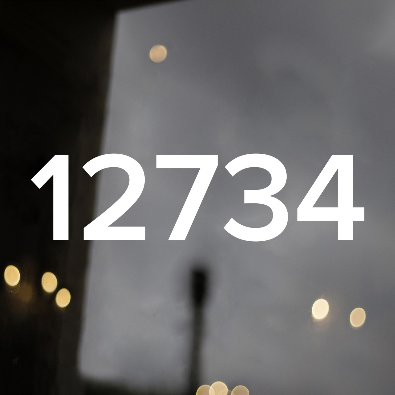 large Proxima Nova vinyl storefront numbers applied to modern business window with geometric minimalist typography