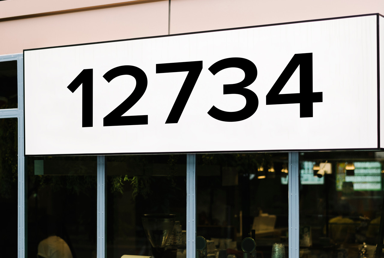 large Proxima Nova vinyl storefront numbers applied to modern business window with geometric minimalist typography