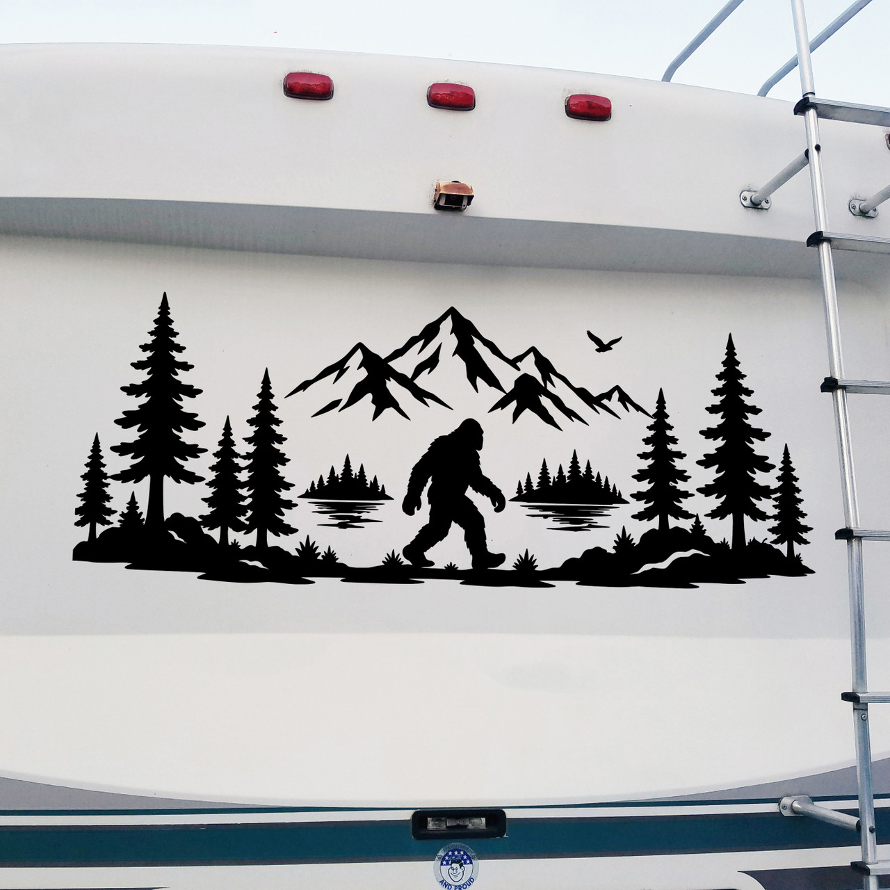 bigfoot mountain lake forest vinyl decal featuring sasquatch walking through pine trees beside a lake with mountain peaks for rvs campers travel trailers trucks and overland vehicles