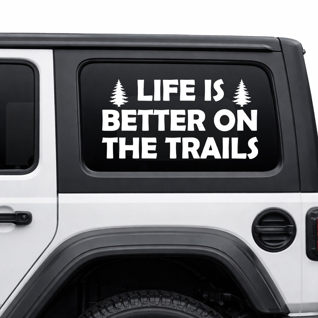 life is better on the trails vinyl decal featuring pine trees and bold lettering designed for trucks, suvs, campers, overland rigs, and outdoor adventure vehicles