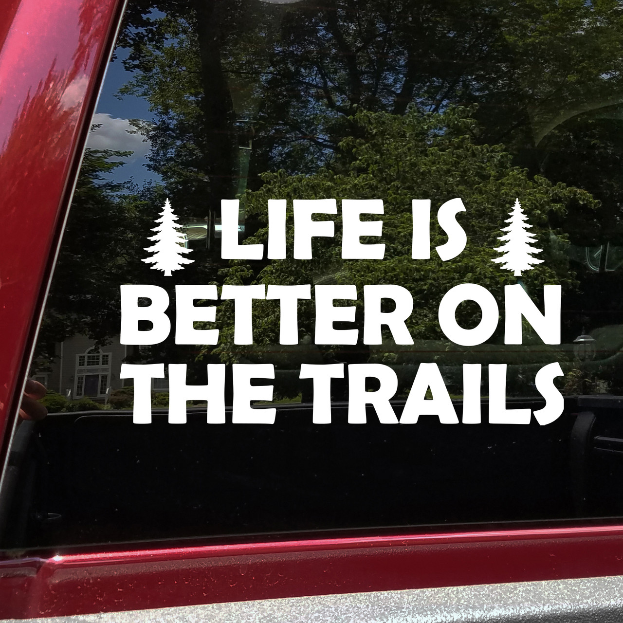 life is better on the trails vinyl decal featuring pine trees and bold lettering designed for trucks, suvs, campers, overland rigs, and outdoor adventure vehicles