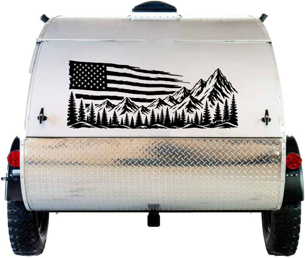 Distressed American flag mountain and pine forest vinyl decal displayed on the rear of an RV motorhome.