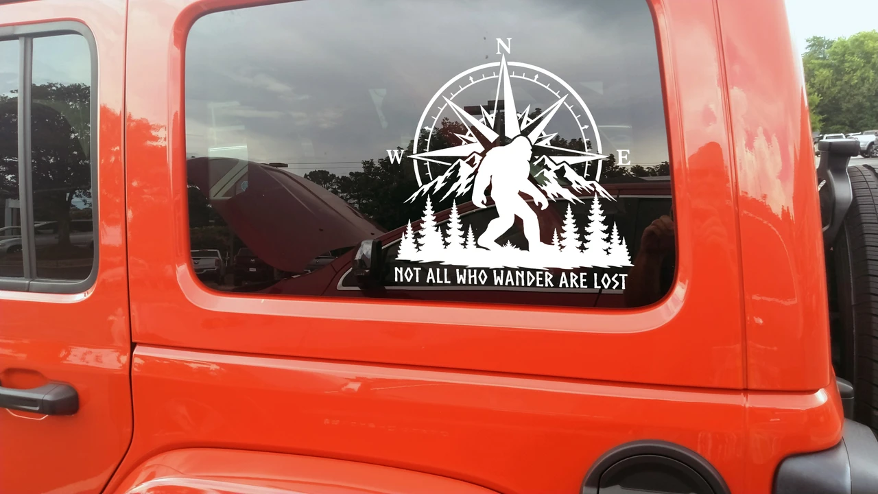 Bigfoot Not All Who Wander Are Lost vinyl decal with compass rose mountains evergreen trees and Sasquatch for truck RV camper and outdoor adventure vehicles